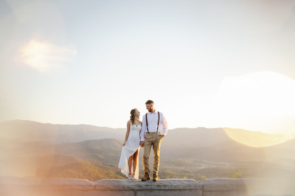 Foothills Parkway Elopement with bride and groom holding hands and staring at each other with cool light editing