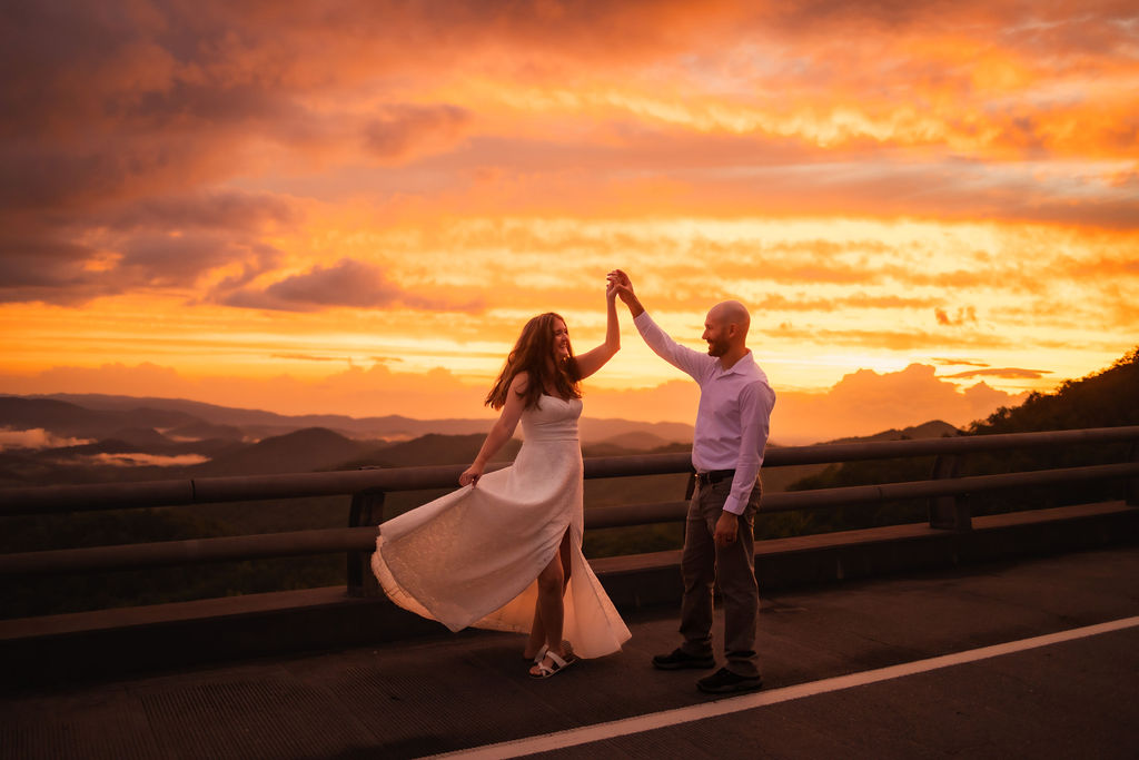 couple eloping to gatlinburg dance on the foothills parkway at sunset