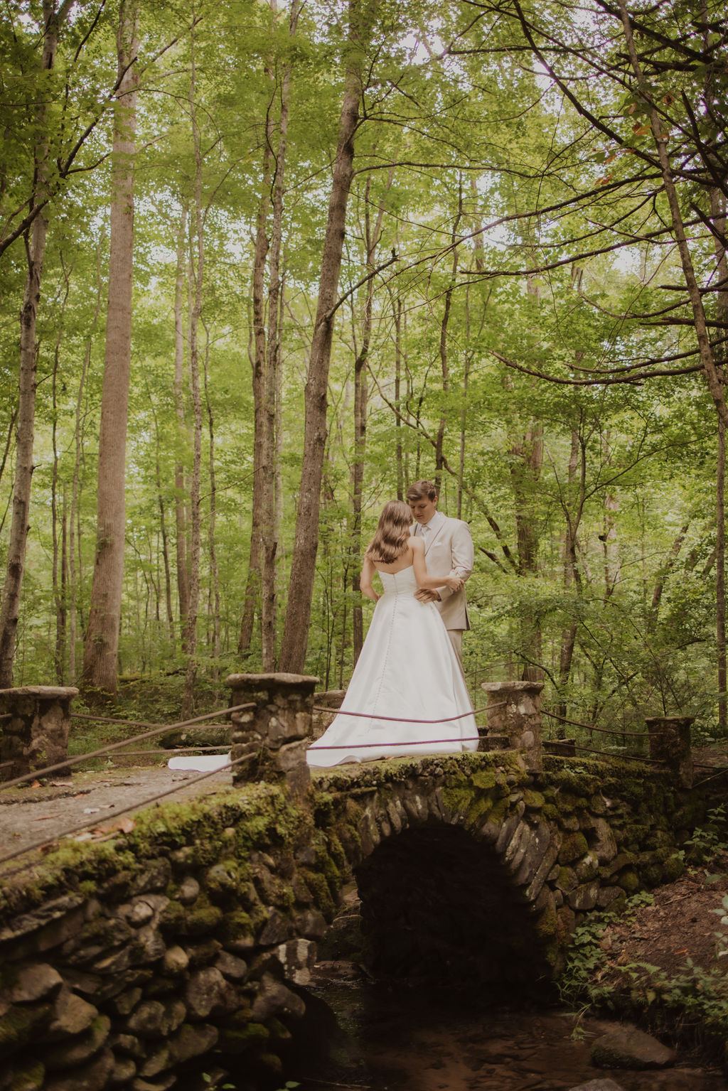 Appalachian Clubhouse wedding with bride and groom on a stone bridge in the woods for a first look captured by photographers in gatlinburg tn