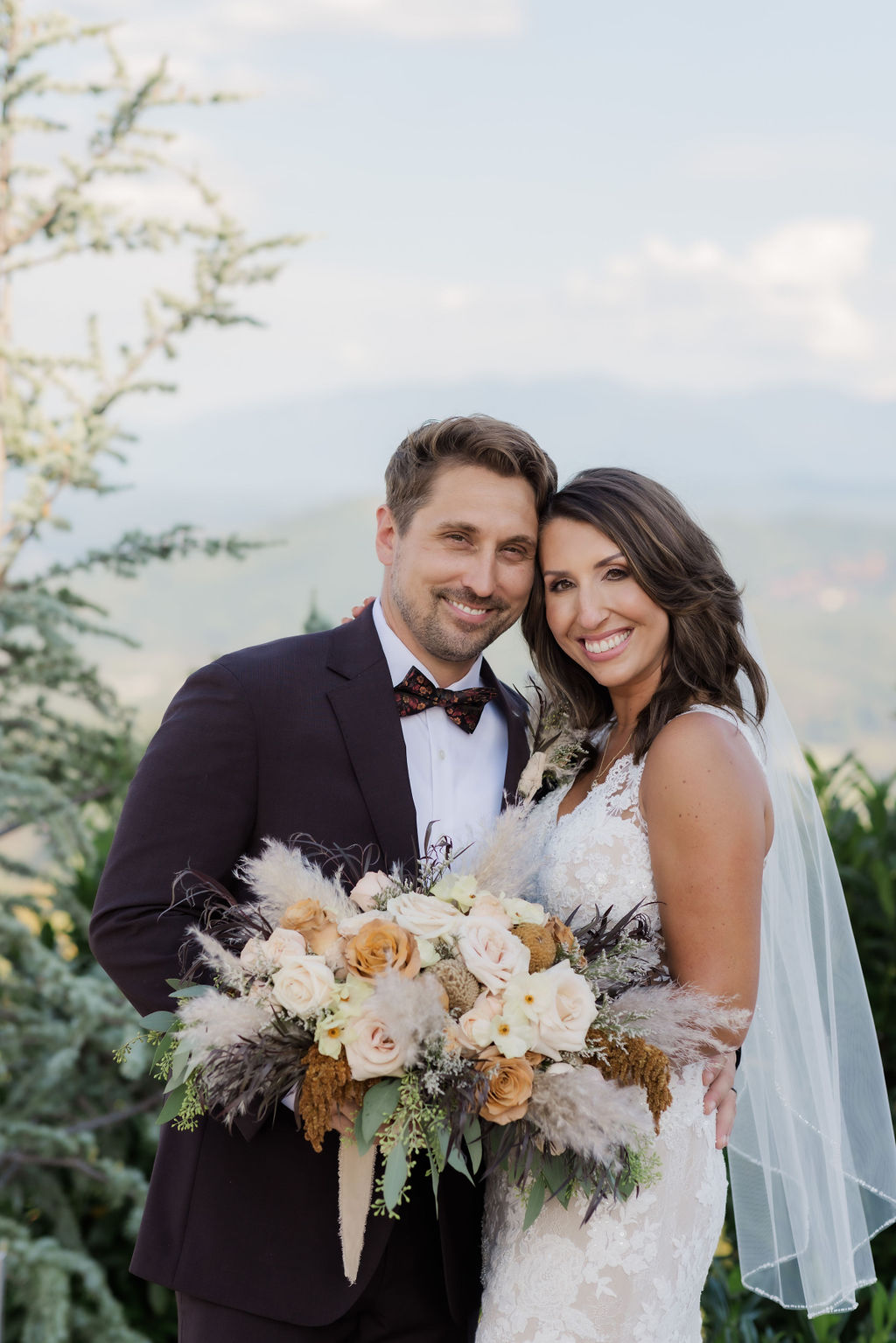 wedding portrait of couple eloping to Gatlinburg as they stand on an outlook with the smoky mountains behind them