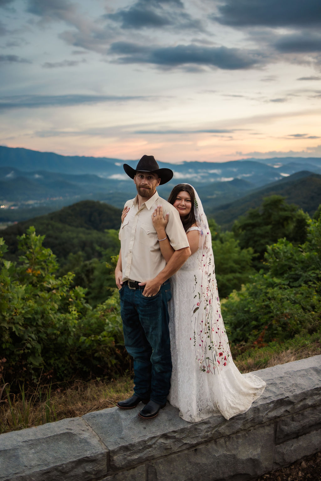 Bride and groom posing together against the mountain backdrop at sunset during their foothills parkway scenic drive elopement, photographed by a Gatlinburg photographer.