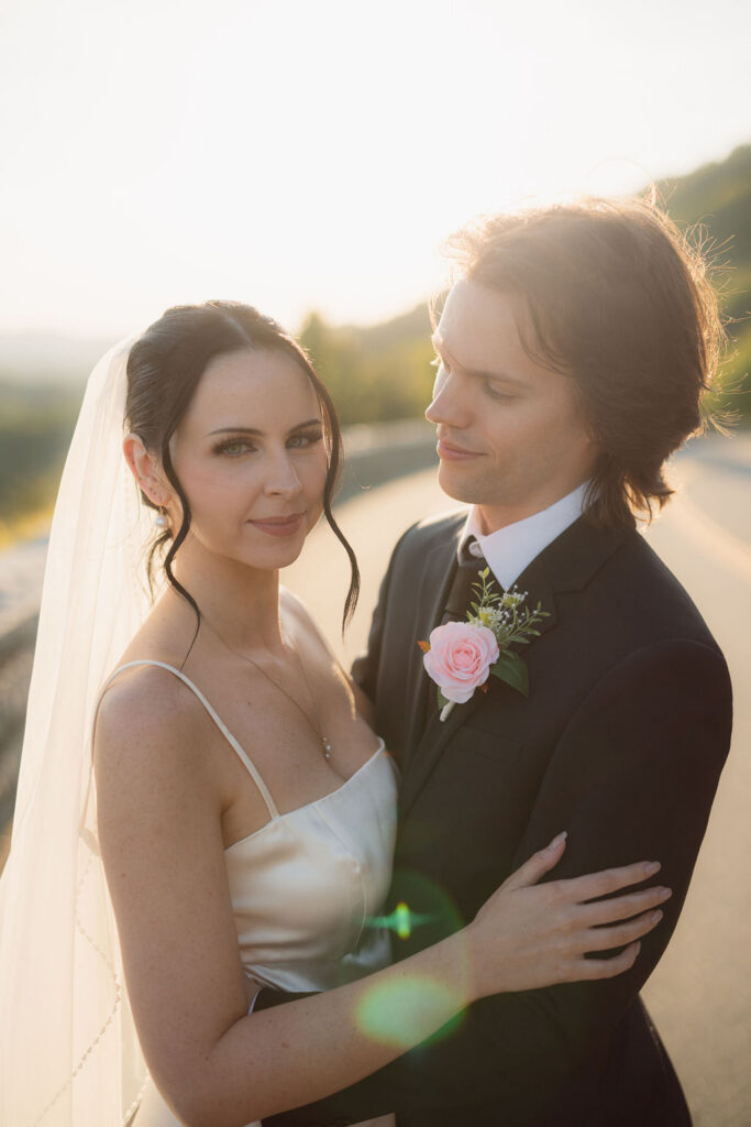 Close-up portrait of a bride and groom in warm sunset light during their Foothills Parkway elopement.
