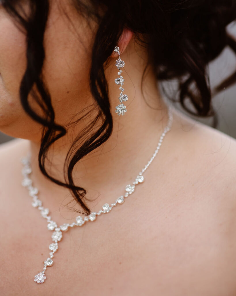 Close-up of sparkling bridal earrings and necklace worn while eloping to Gatlinburg at foothills parkway.