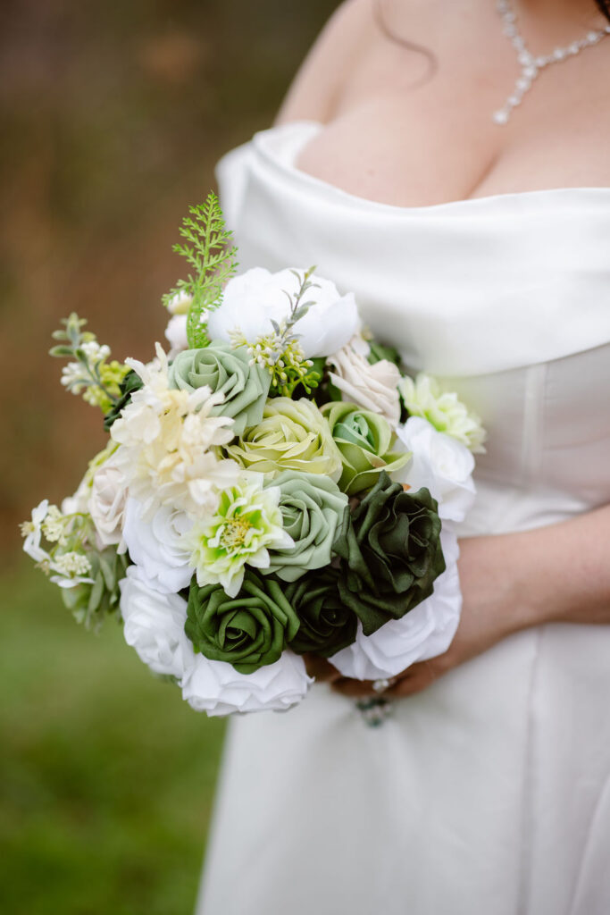 Close-up of a white and green bridal bouquet during a ceremony while eloping to Gatlinburg at foothills parkway.