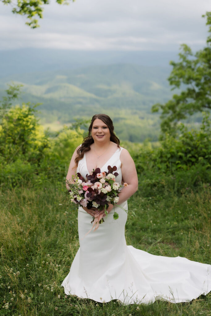 Bride holding a colorful bouquet with mountain views along Foothills Parkway, highlighting the beauty of eloping to Gatlinburg.