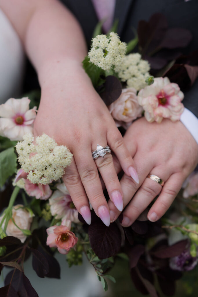 Close-up of the couple's wedding bands resting on a floral bouquet during their Foothills Parkway ceremony while eloping to Gatlinburg.