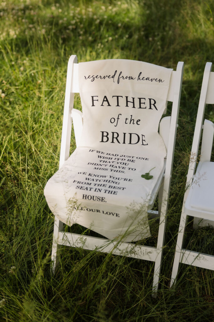 Memorial chair honoring the father of the bride with a “reserved from heaven” tribute during an intimate Gatlinburg elopement.